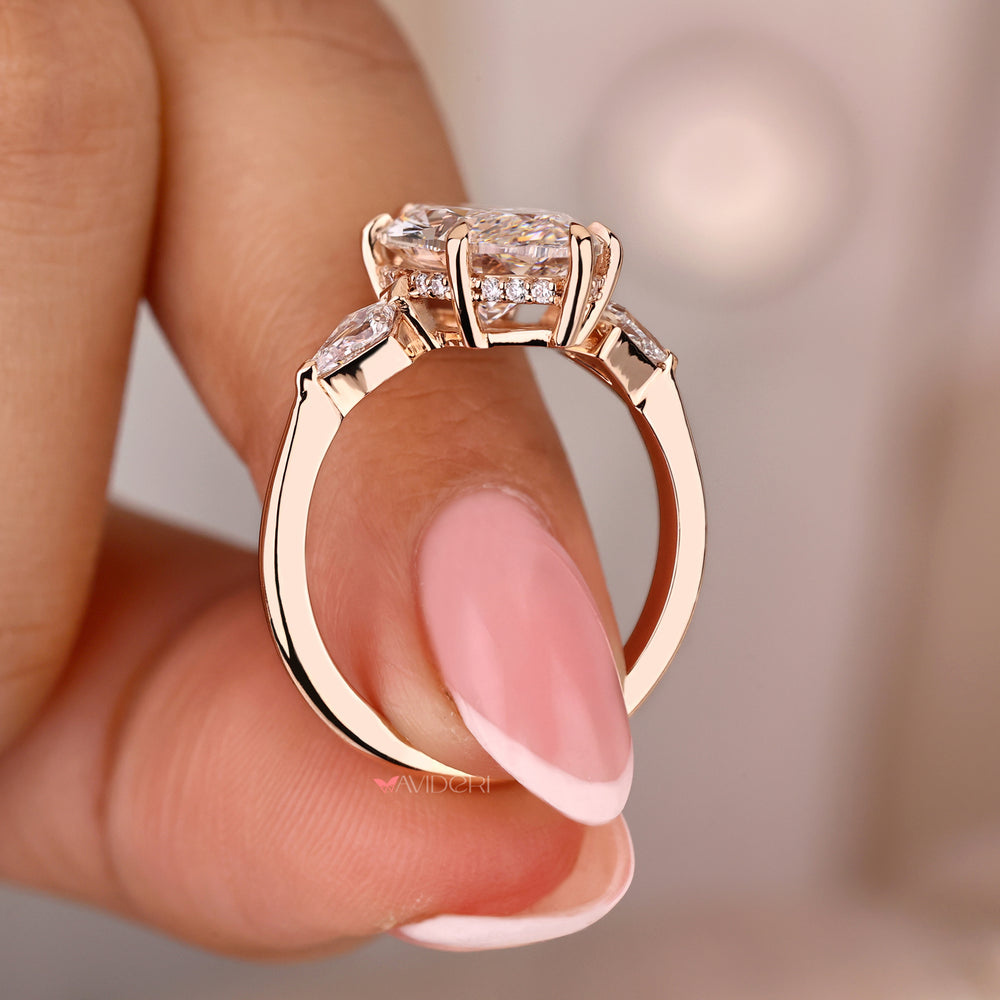 Three stone engagement ring with a captivating marquise centerpiece

