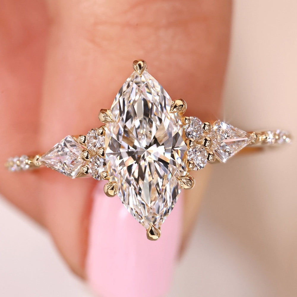 Marquise diamond engagement ring in yellow gold on the Finger.
