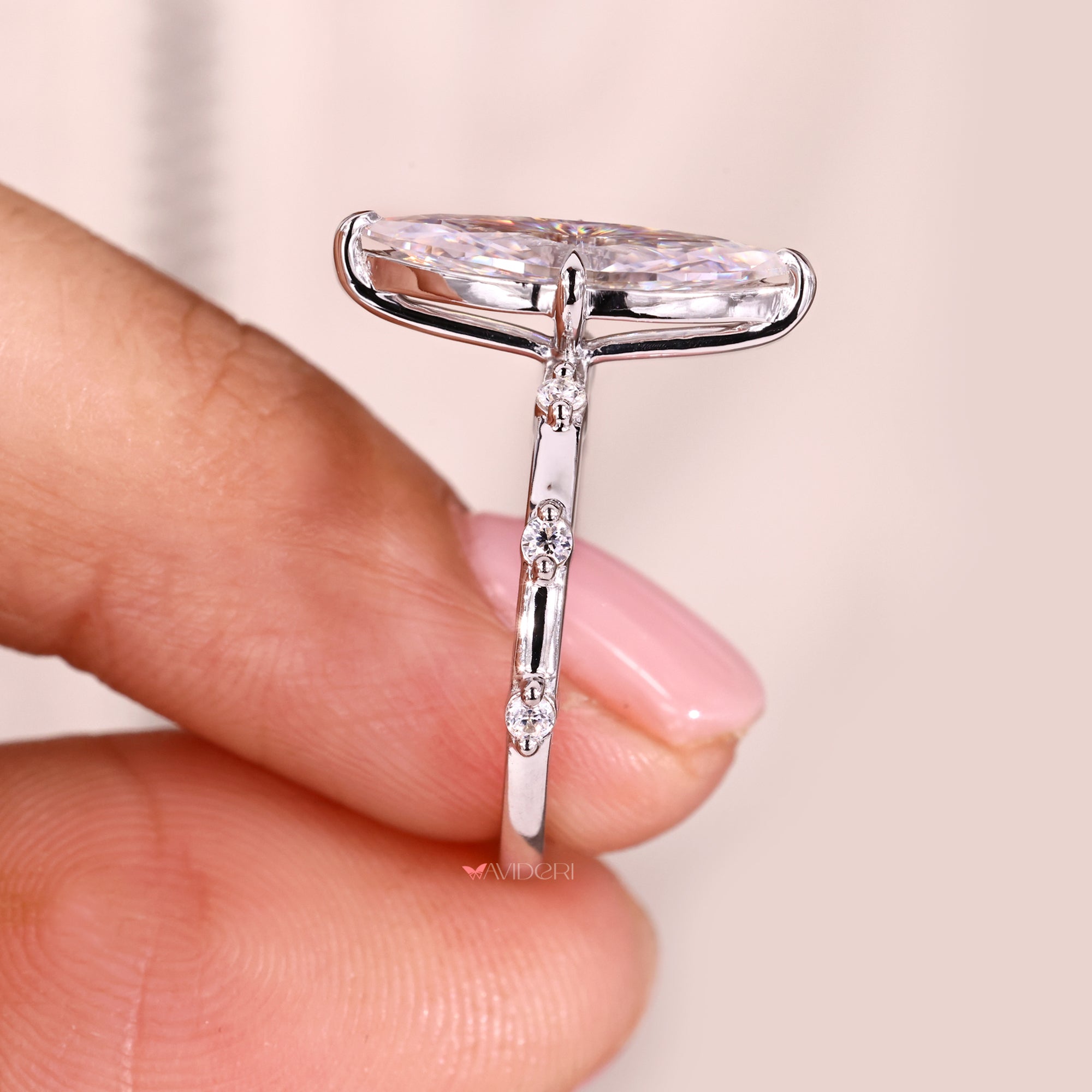 This round cut distance pave set delivers intricate sparkle with precise craftsmanship.