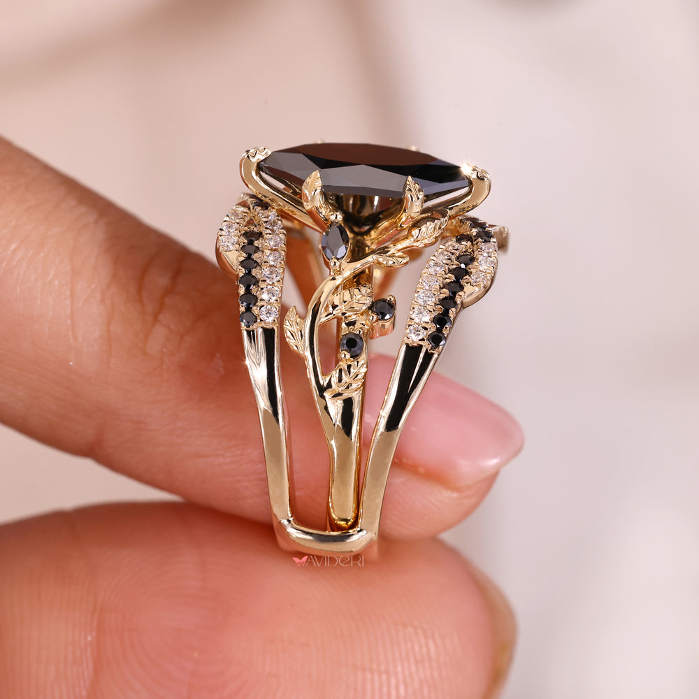 Nature inspired engagement ring with black moissanite and gold finish.