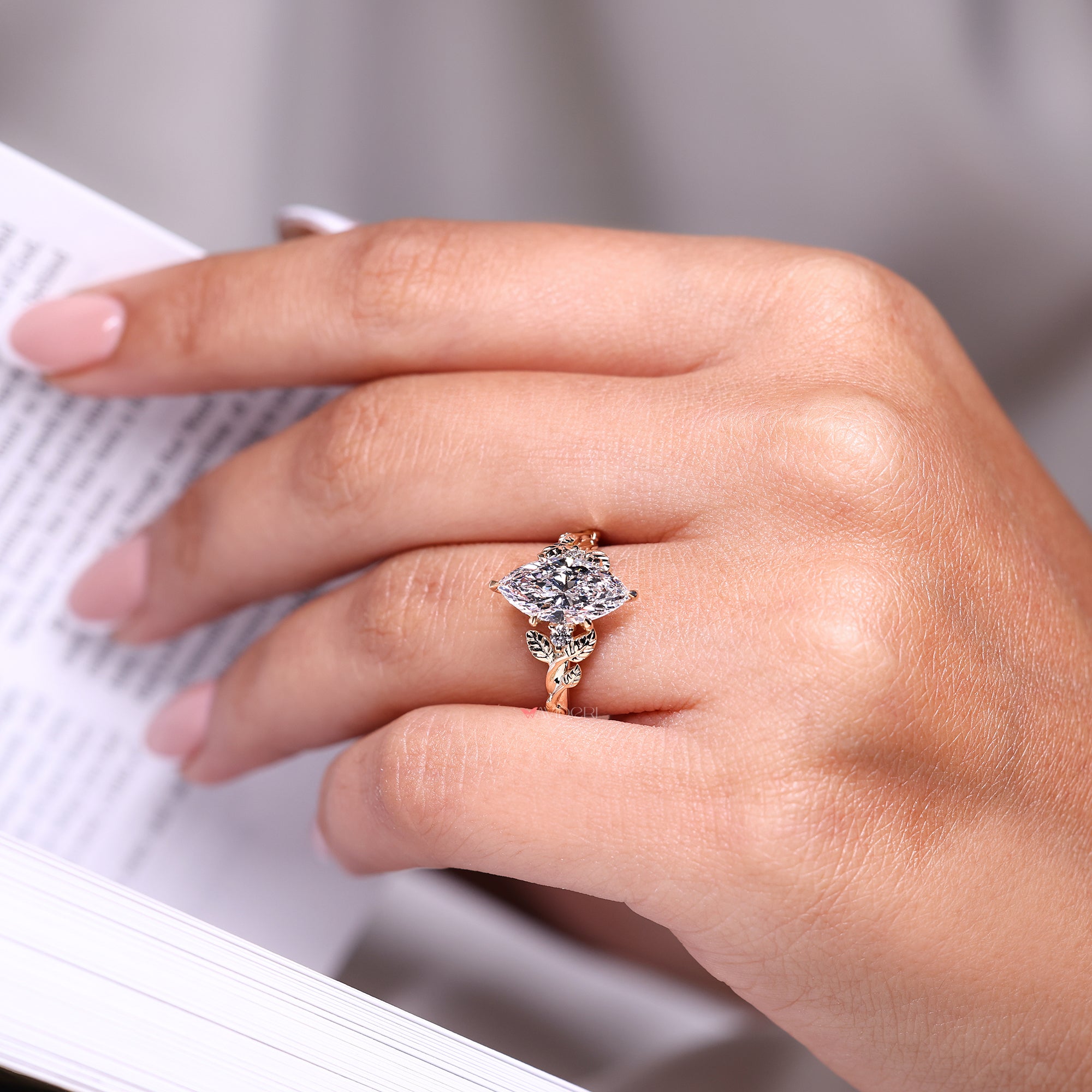 Nature inspired engagement ring with three stone diamond design.