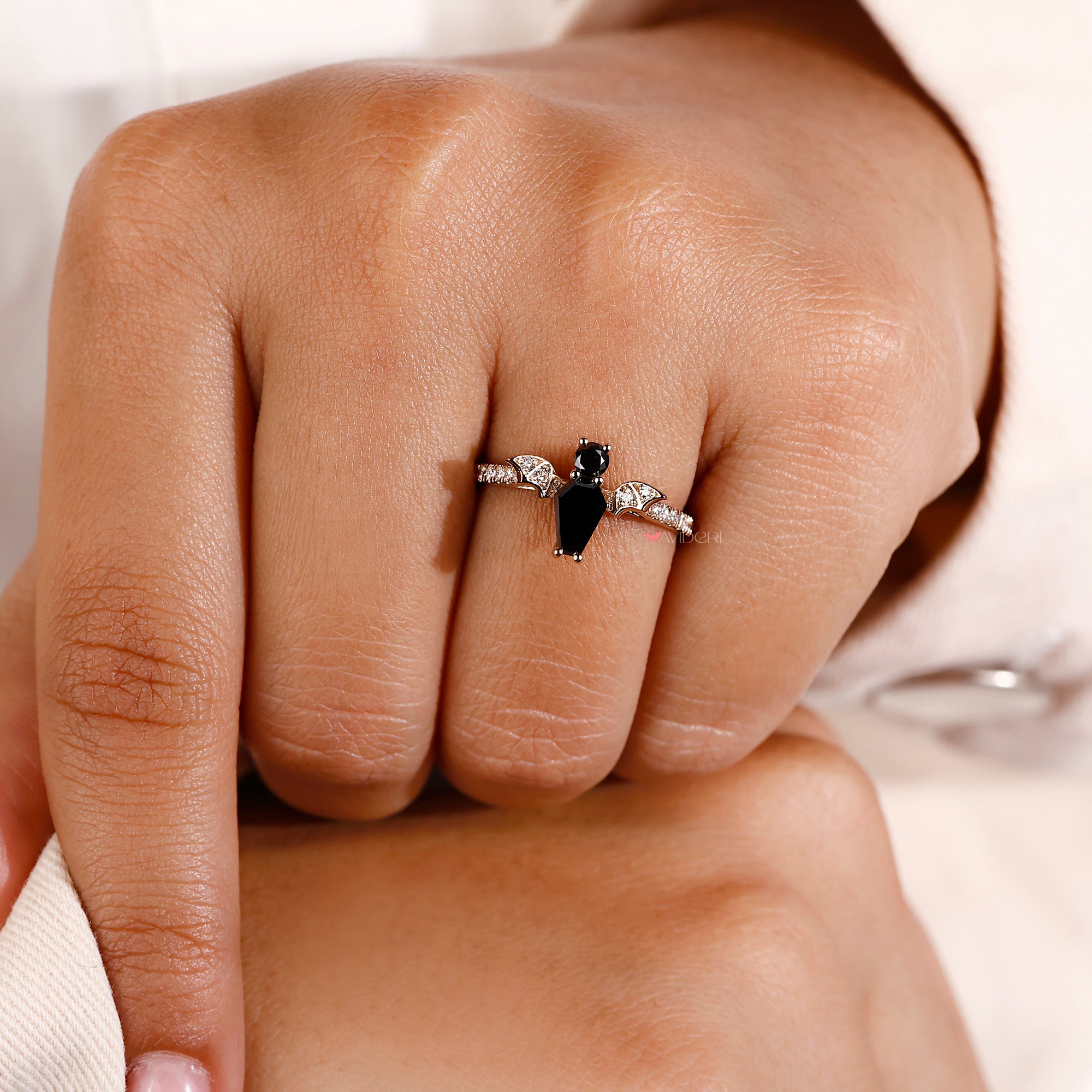 Black coffin engagement ring in round cut side stone.