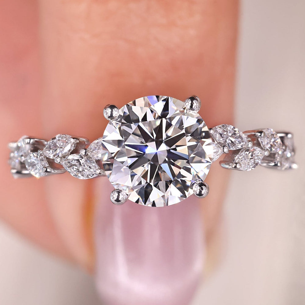 Round diamond engagement ring set in white gold, with a pave setting for added brilliance.
