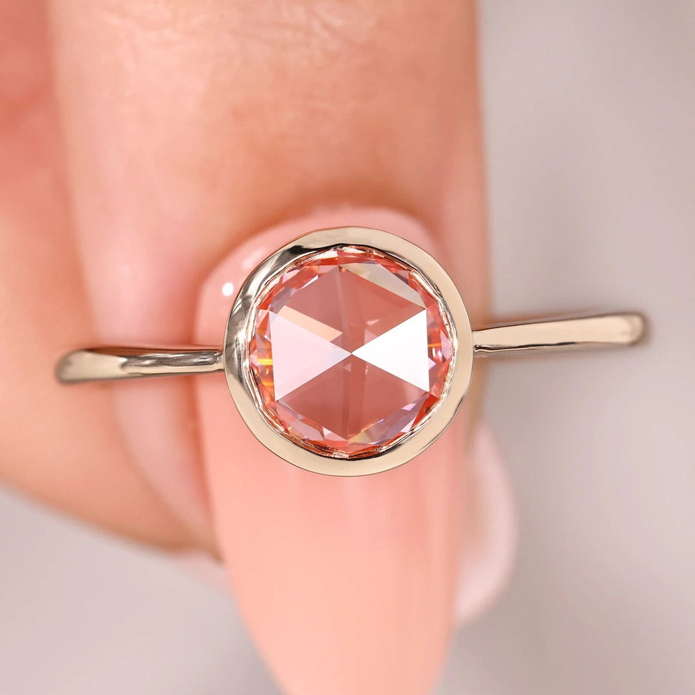 Pink diamond ring with tapered shank ring.