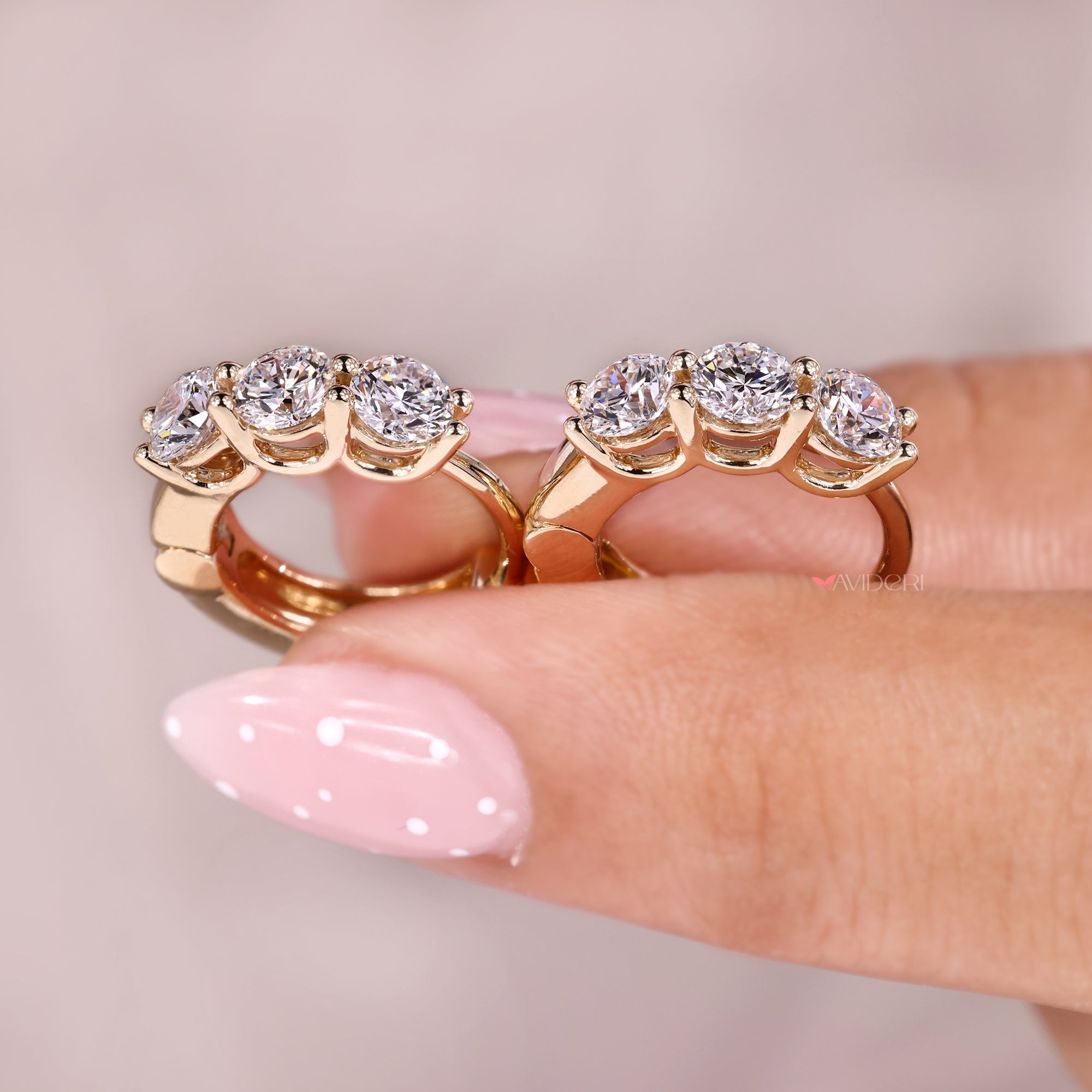 Shared prong setting with gold diamond hoop earrings.

