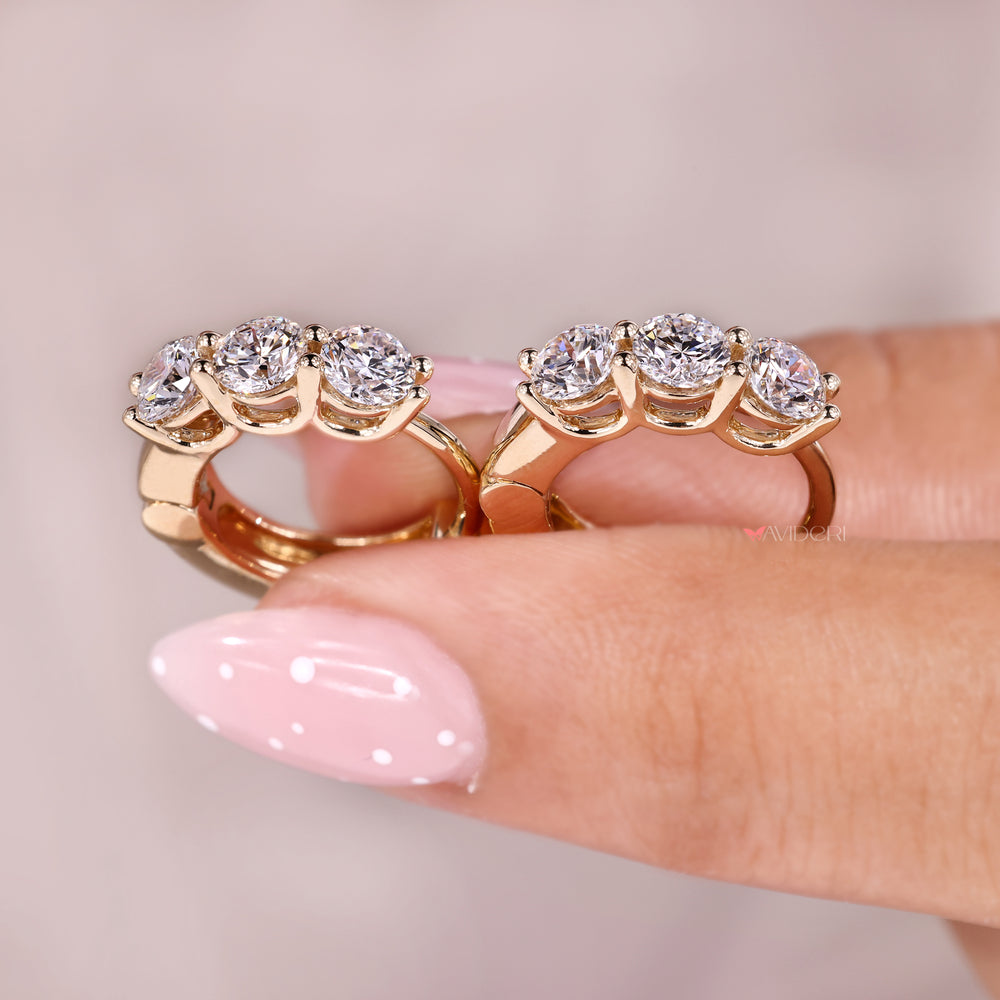 Shared prong setting with gold diamond hoop earrings.
