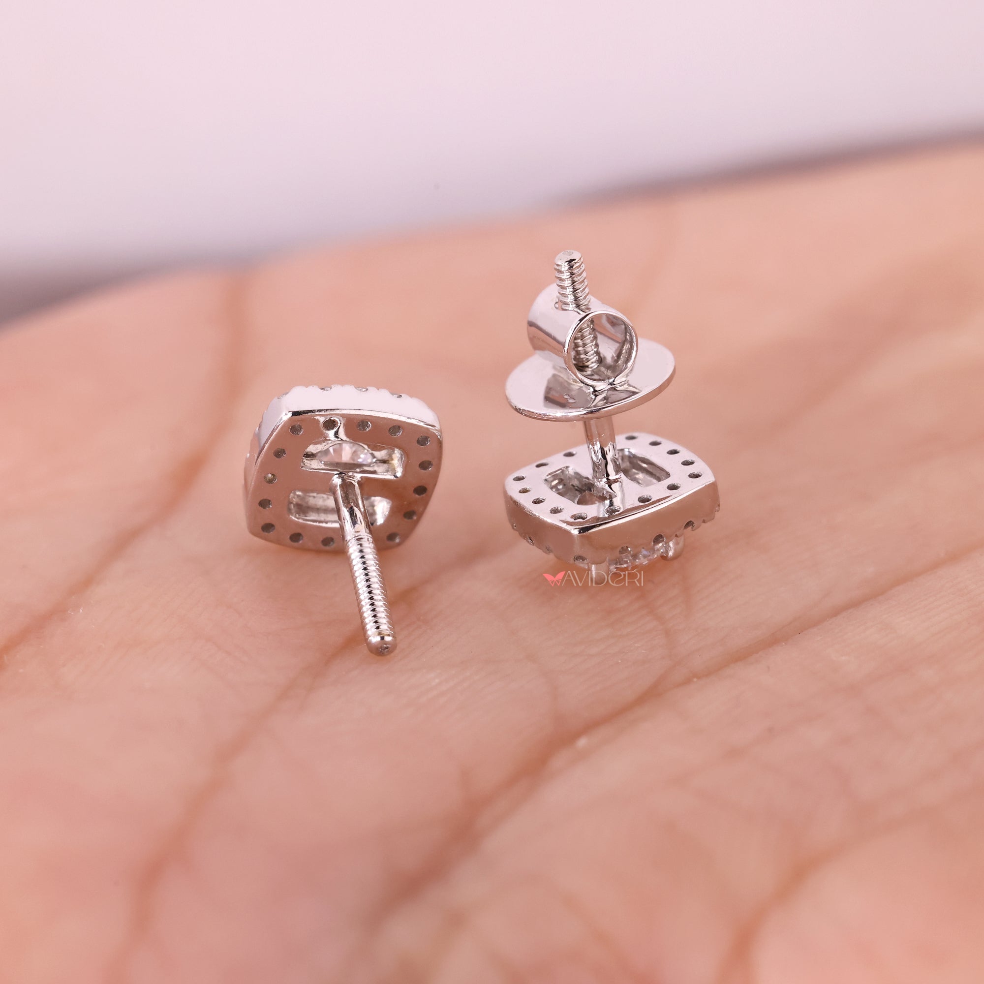 White gold earrings with round diamond studs.