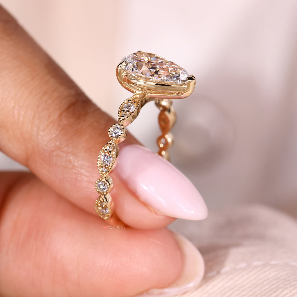 Stunning pear shaped ring featuring a brilliant diamond centerpiece.
