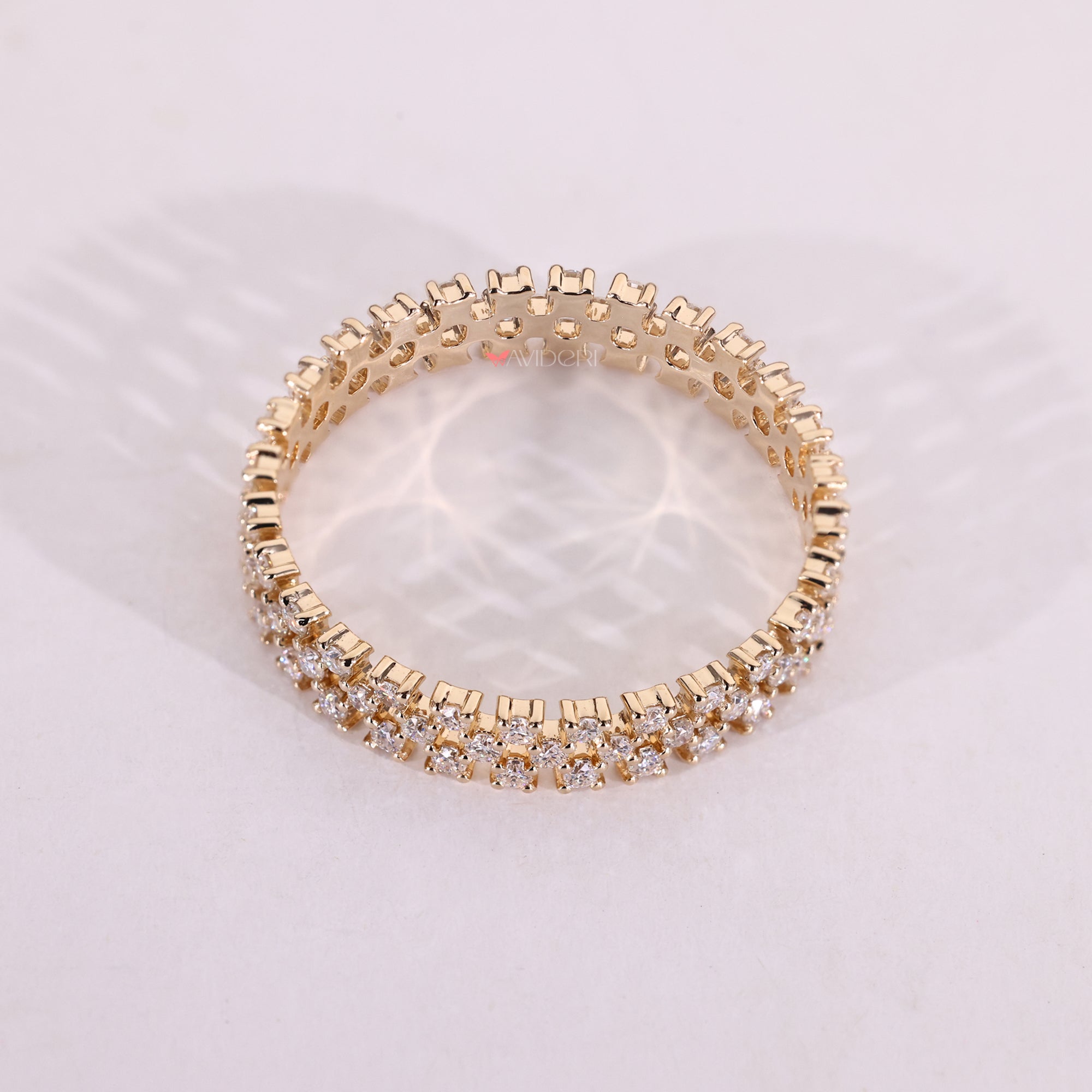 Yellow gold wedding band with round moissanite.