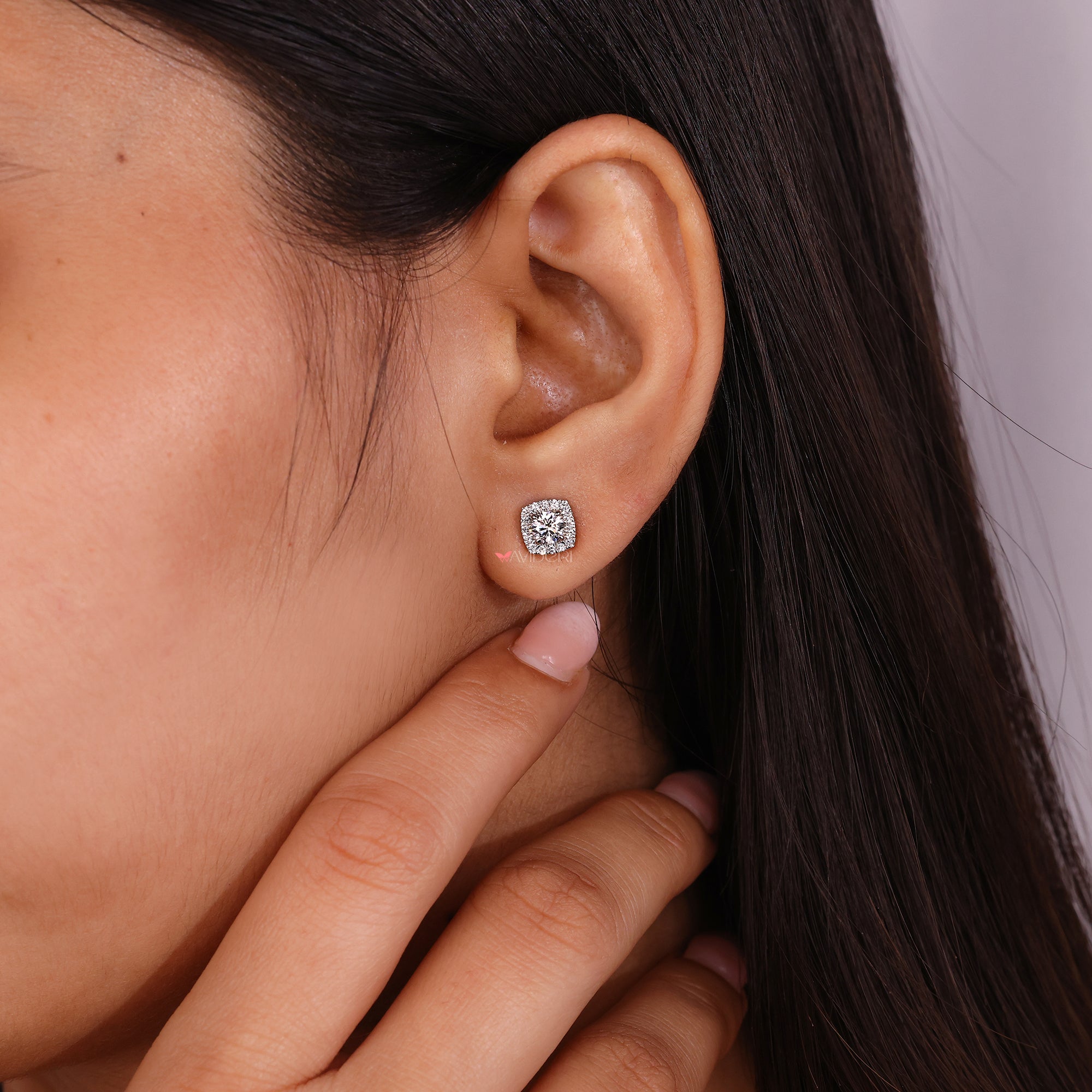 Four claw prong earrings holding round diamonds.