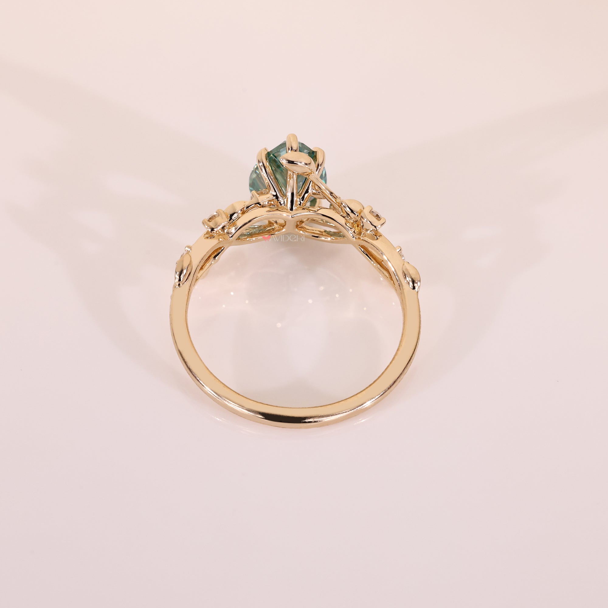 Yellow gold engagement ring with round cut side stone.