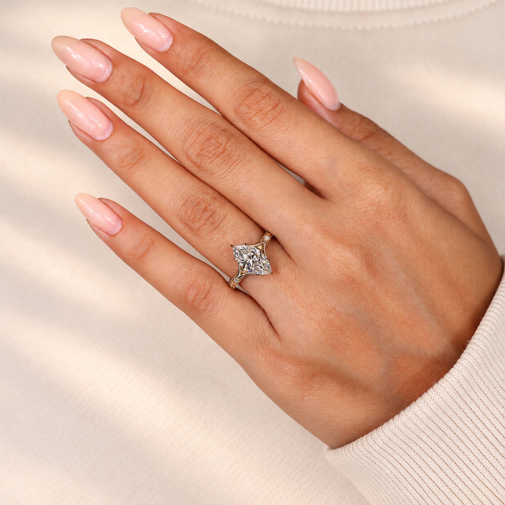 Marquise diamond ring with round diamond sides.
