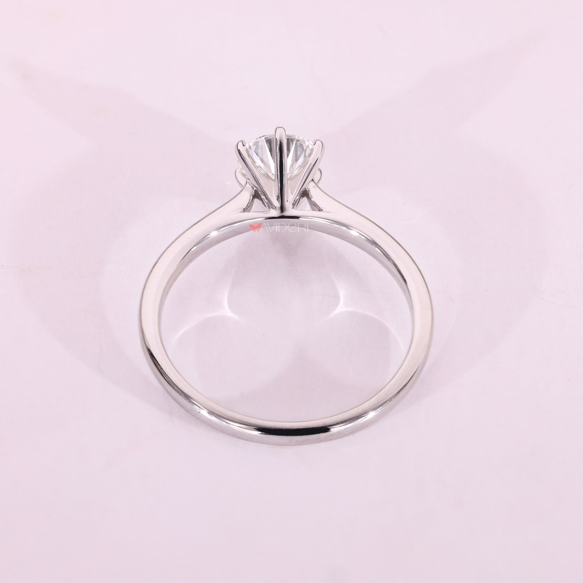 White gold solitaire ring with cathedral setting.