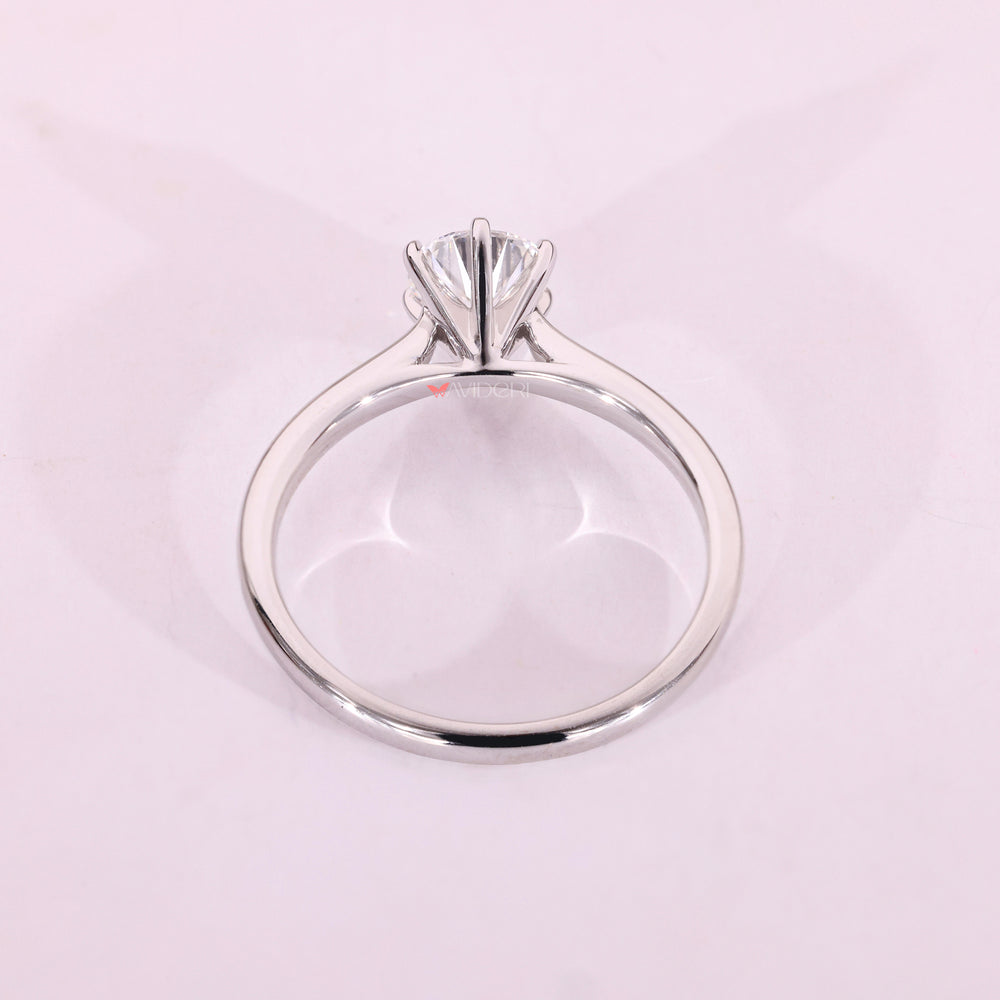 White gold solitaire ring with cathedral setting.