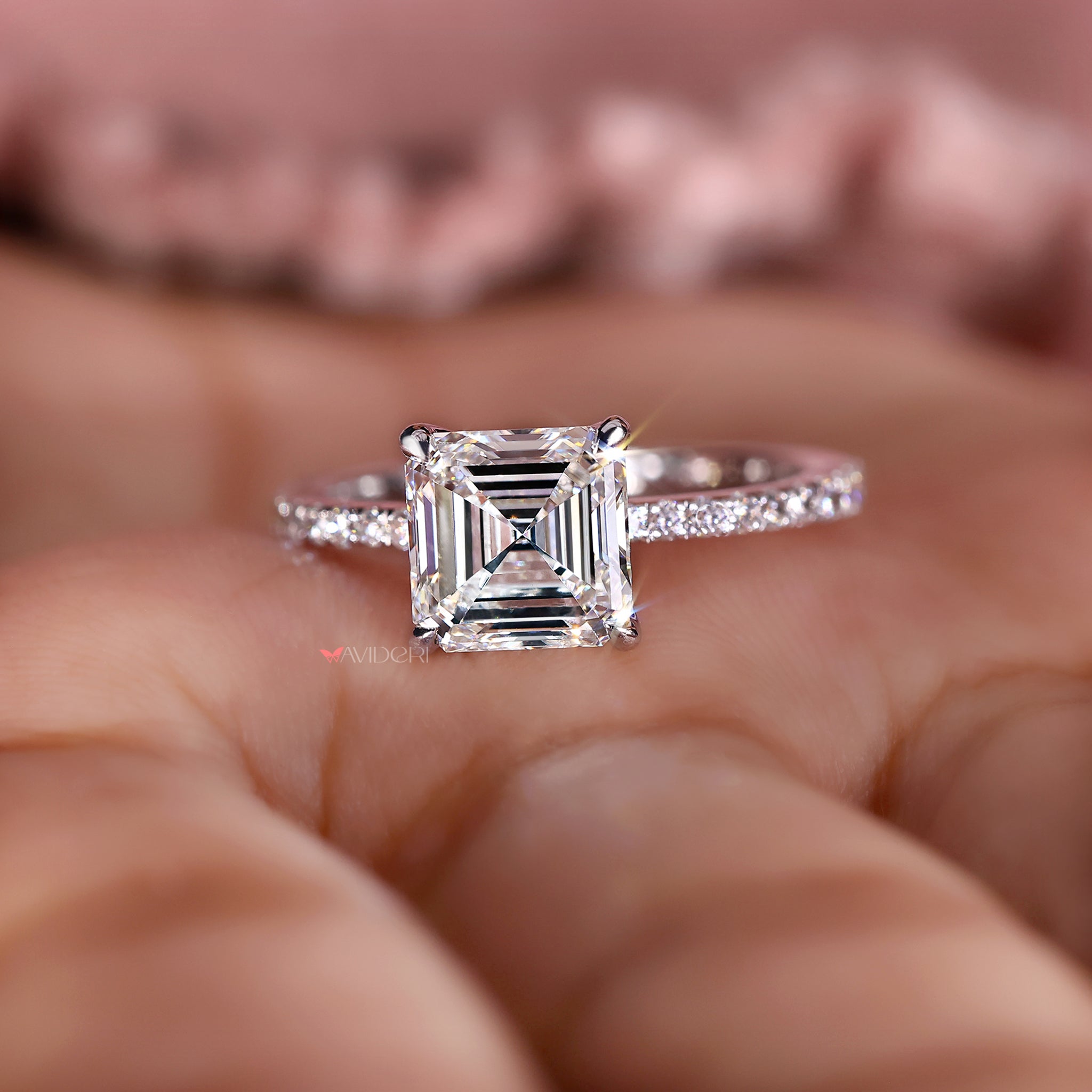 Asscher cut diamond ring with elegant pave setting.
