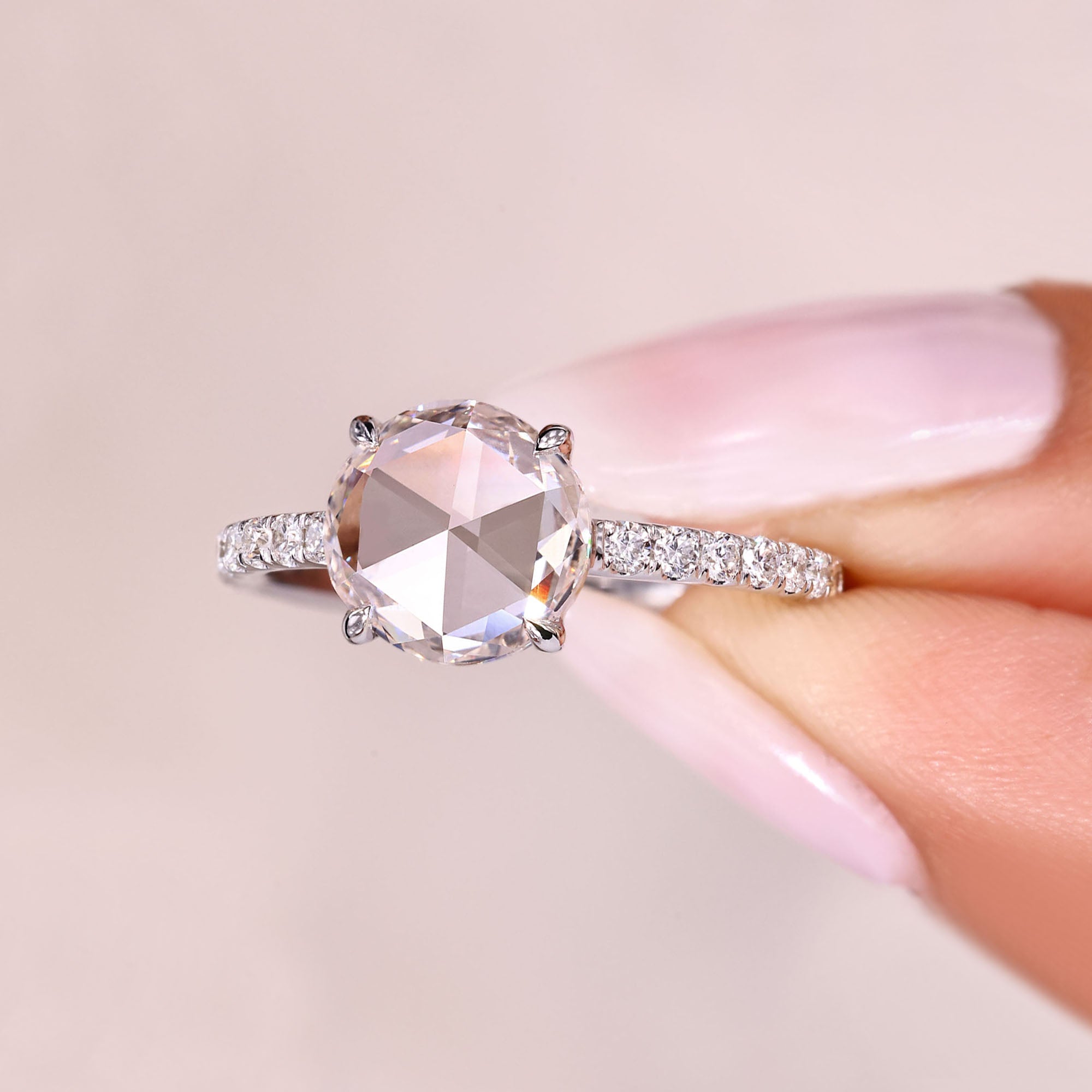 Rose cut diamond ring featuring round diamond pave accents.
