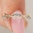 Twisted wedding band with round diamonds and nature inspired design
