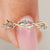 Twisted wedding band with round diamonds and nature inspired design
