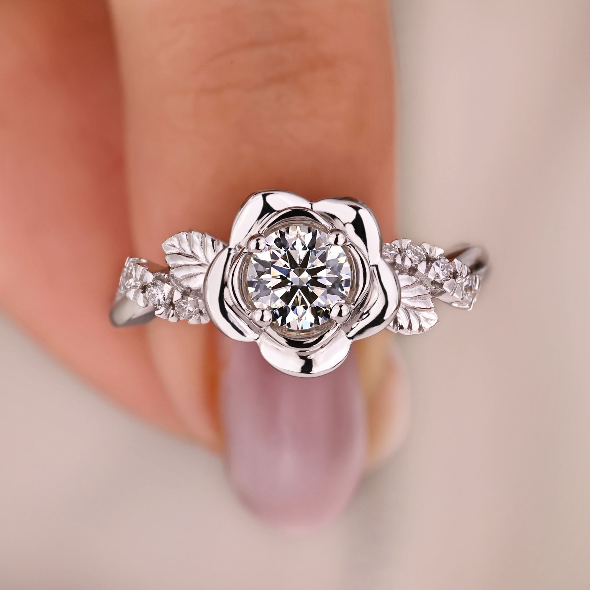 Rose-inspired engagement ring with twisted pave band.
