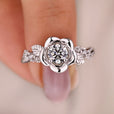 Rose-inspired engagement ring with twisted pave band.
