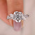Rose-inspired engagement ring with twisted pave band.
