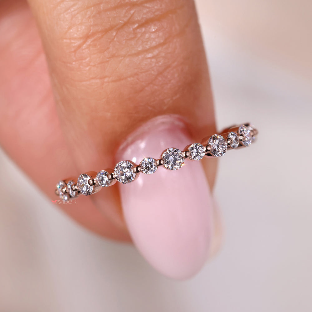 Avideri wedding band featuring round diamond eternity band in an elegant setting.
