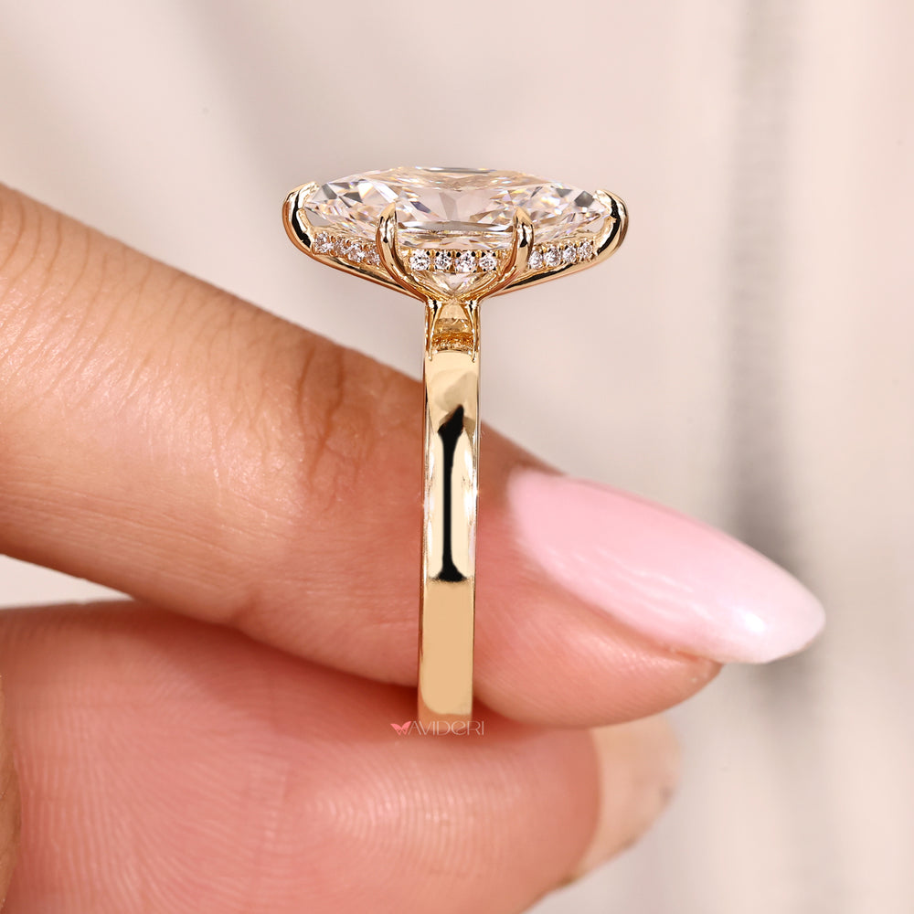 Six claw prong marquise diamond ring with hidden halo.