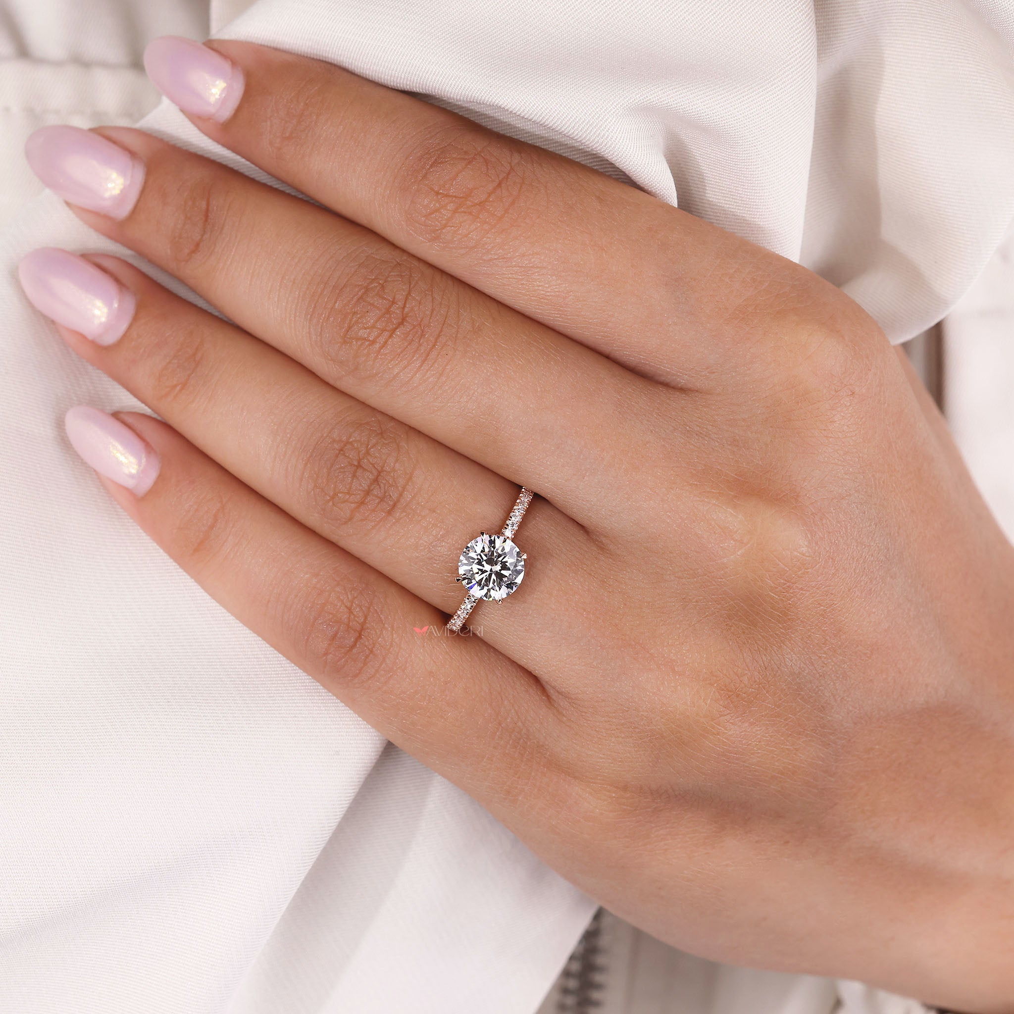 Round diamond hidden halo set in an Open Gallery ring and rose gold engagement ring design.
