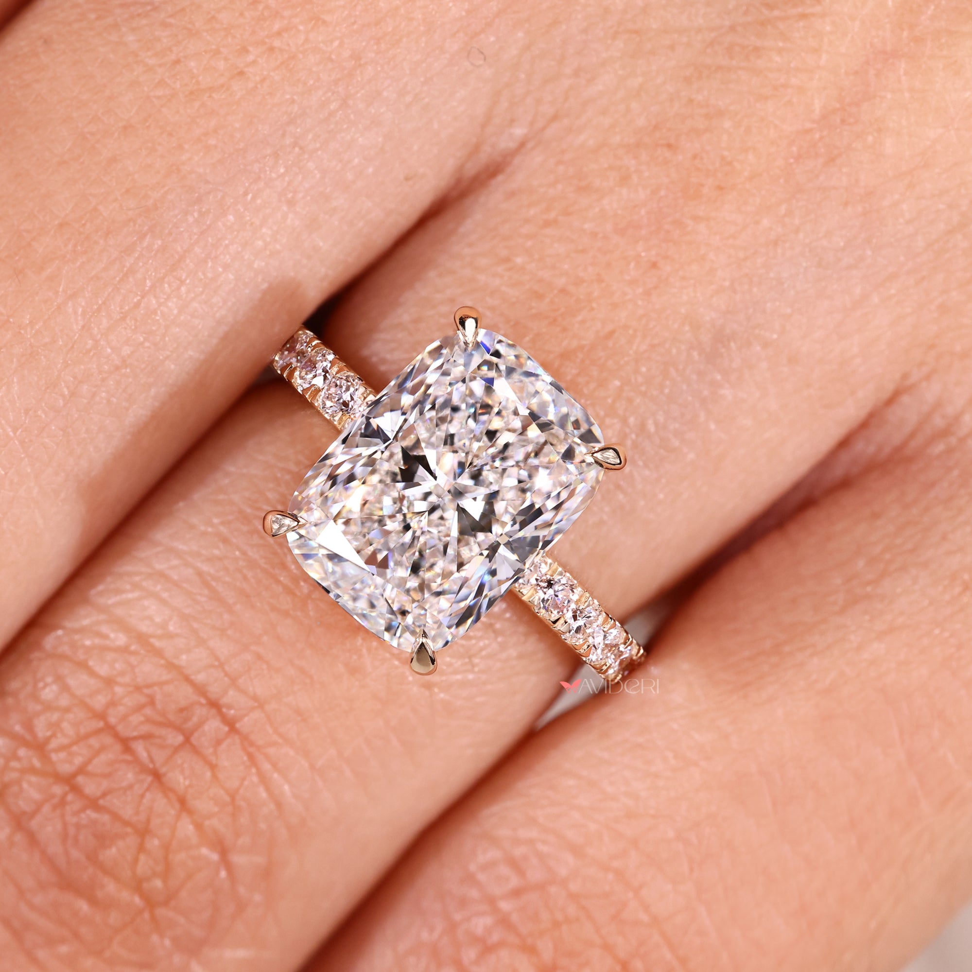 Handmade cushion cut diamond ring with four claw prong.
