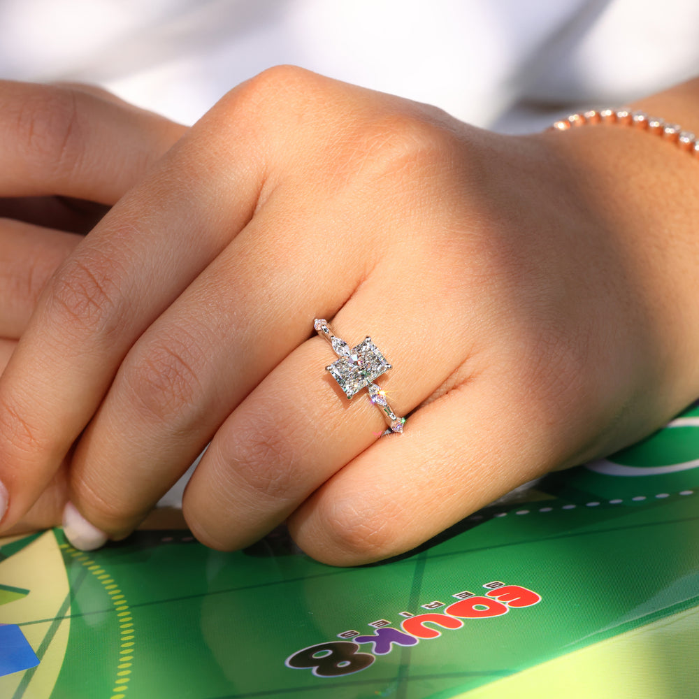 Marquise cut diamond ring with a radiant engagement ring setting.
