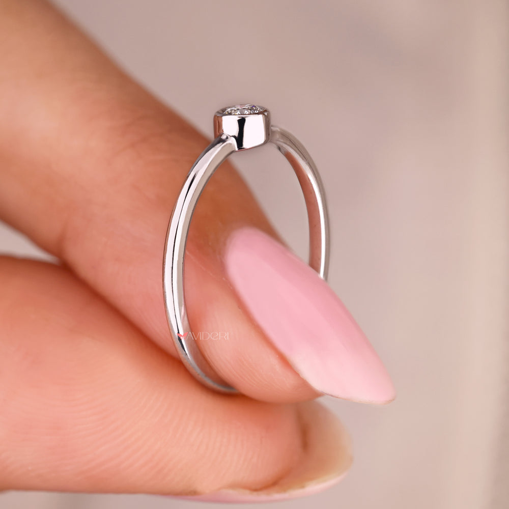 Lab grown round diamond ring in sleek bezel setting.

