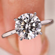 Round diamond solitaire ring with hidden halo and tapered shank