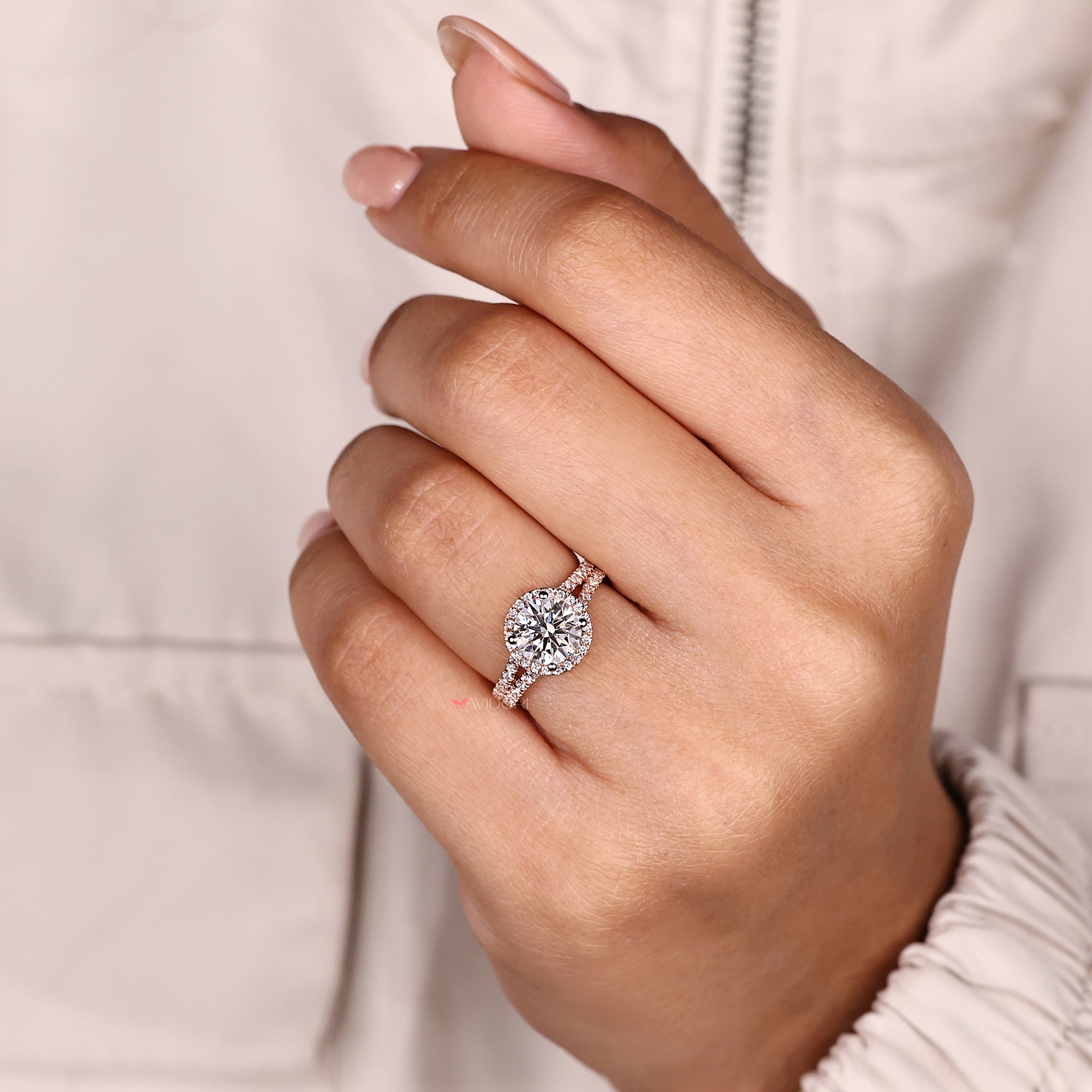 Sparkling round diamond halo ring with pave band.
