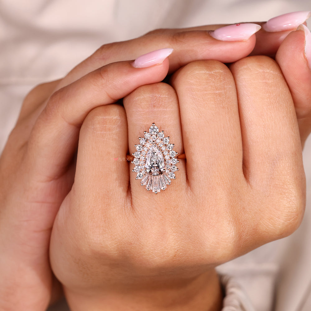 Snowflake style pear cut diamond ring with round halo.