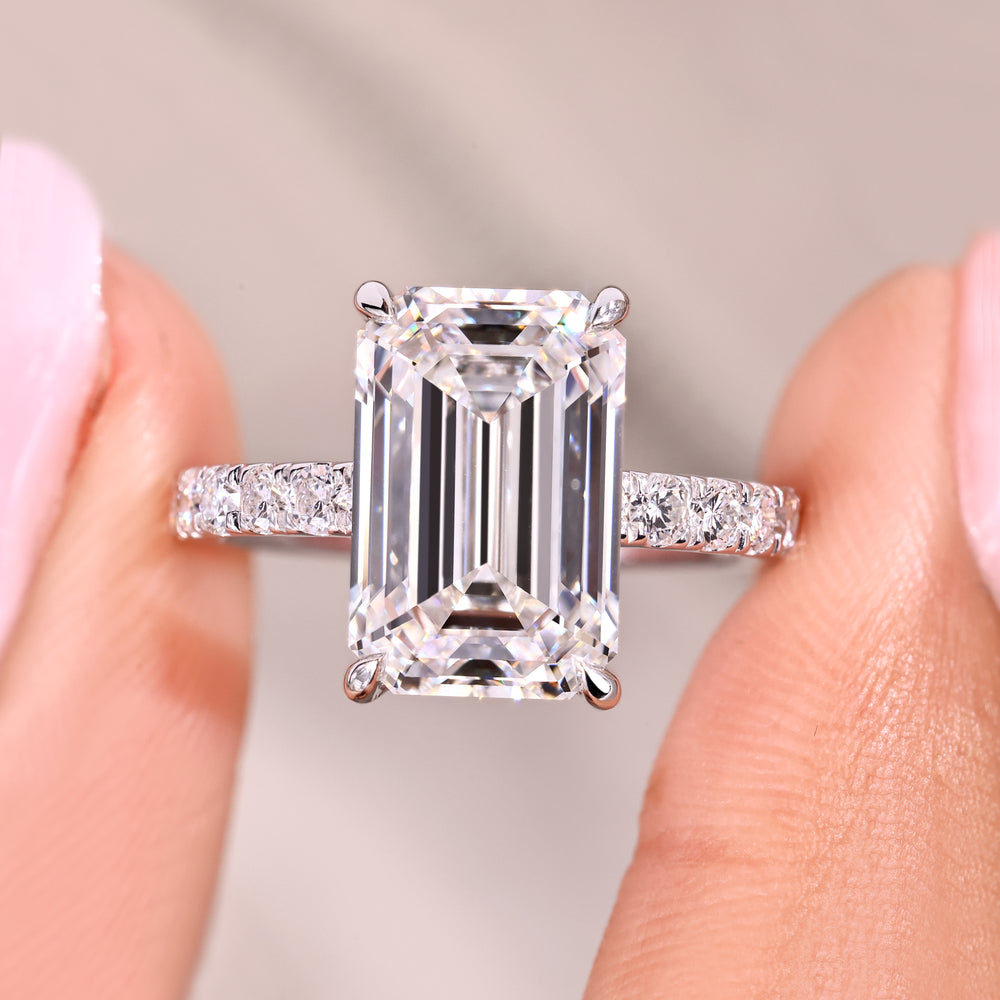 Emerald cut diamond ring with modern pave design.
