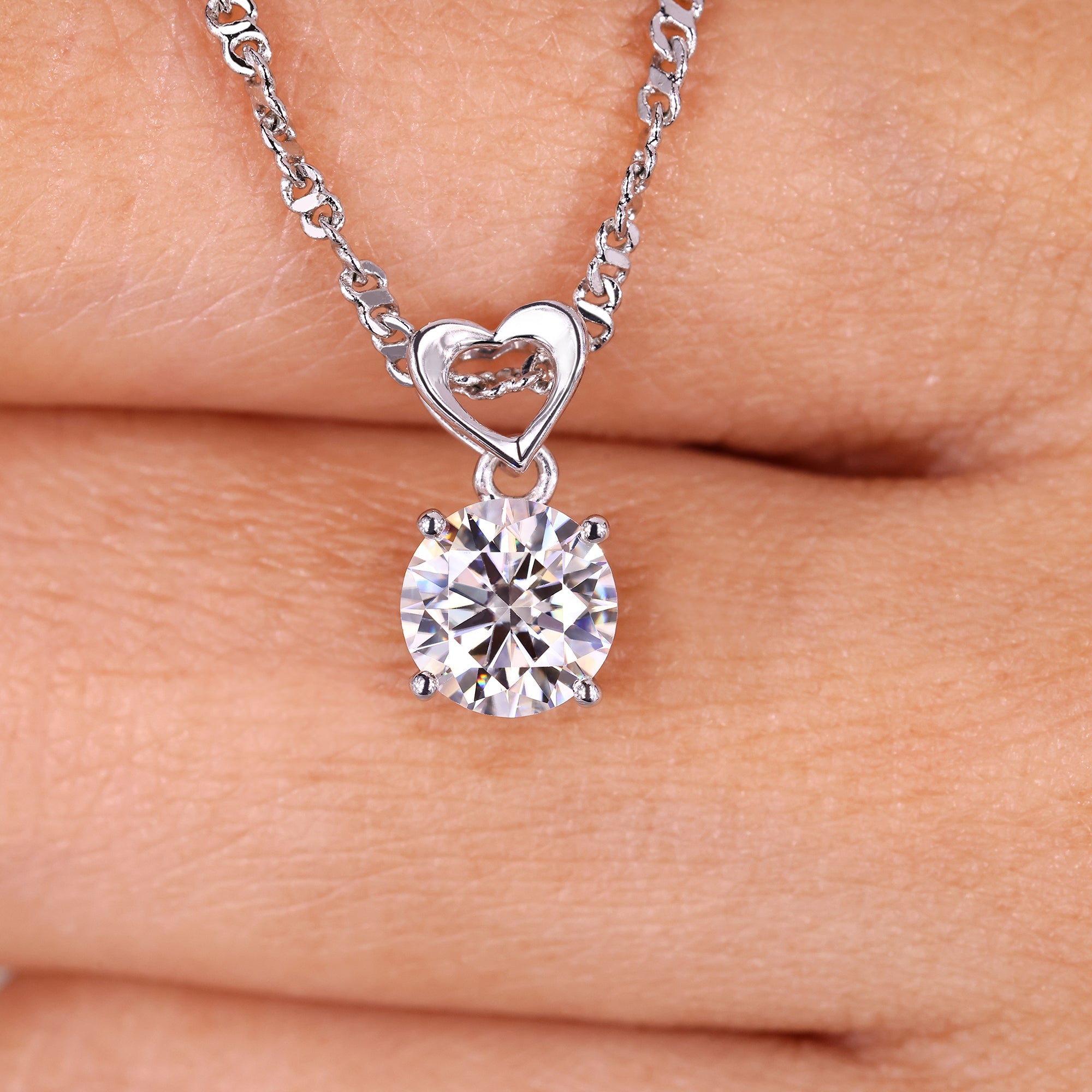 Oval cut solitaire pendant in a handmade jewelry collection.