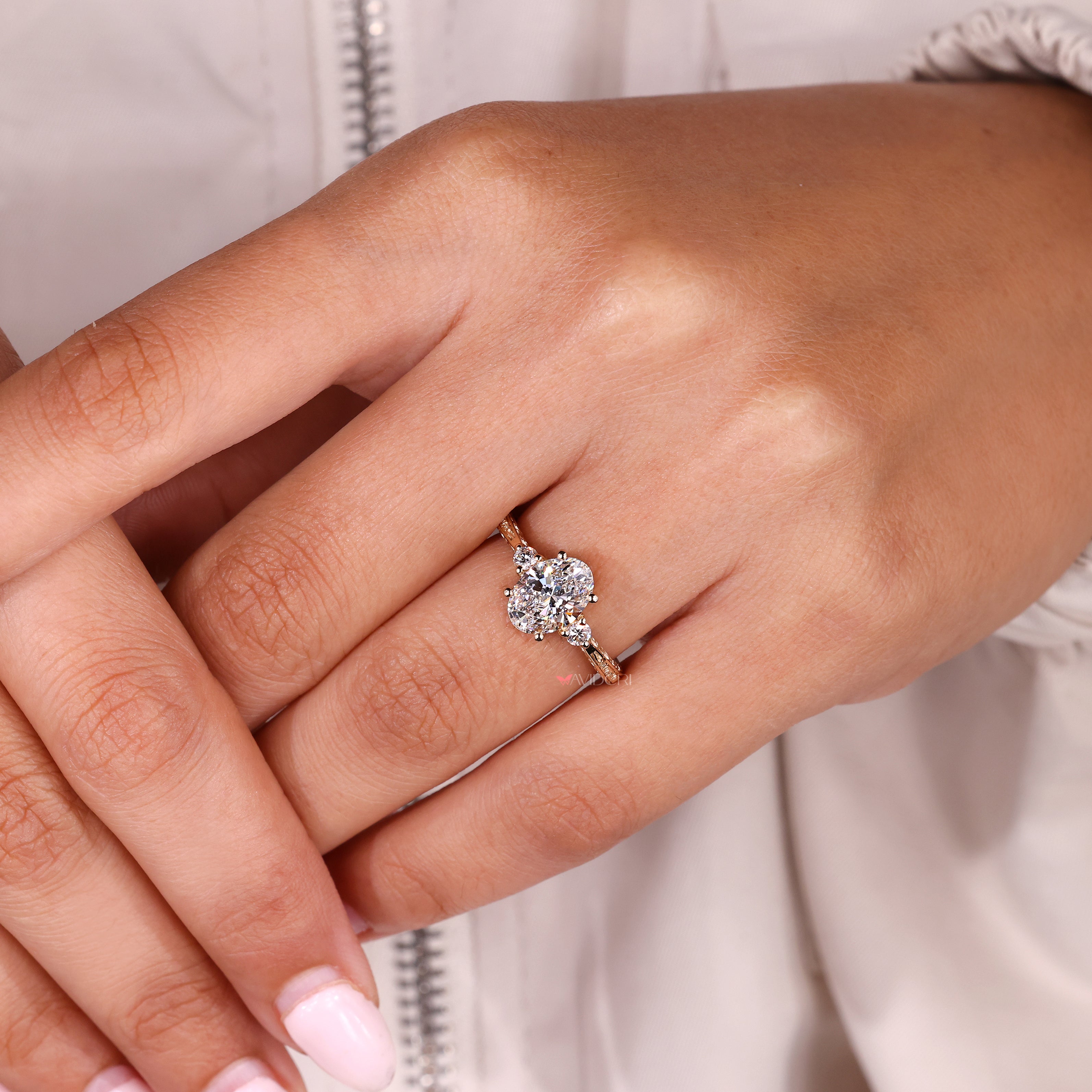 Three stone oval diamond ring with tapered shank style
