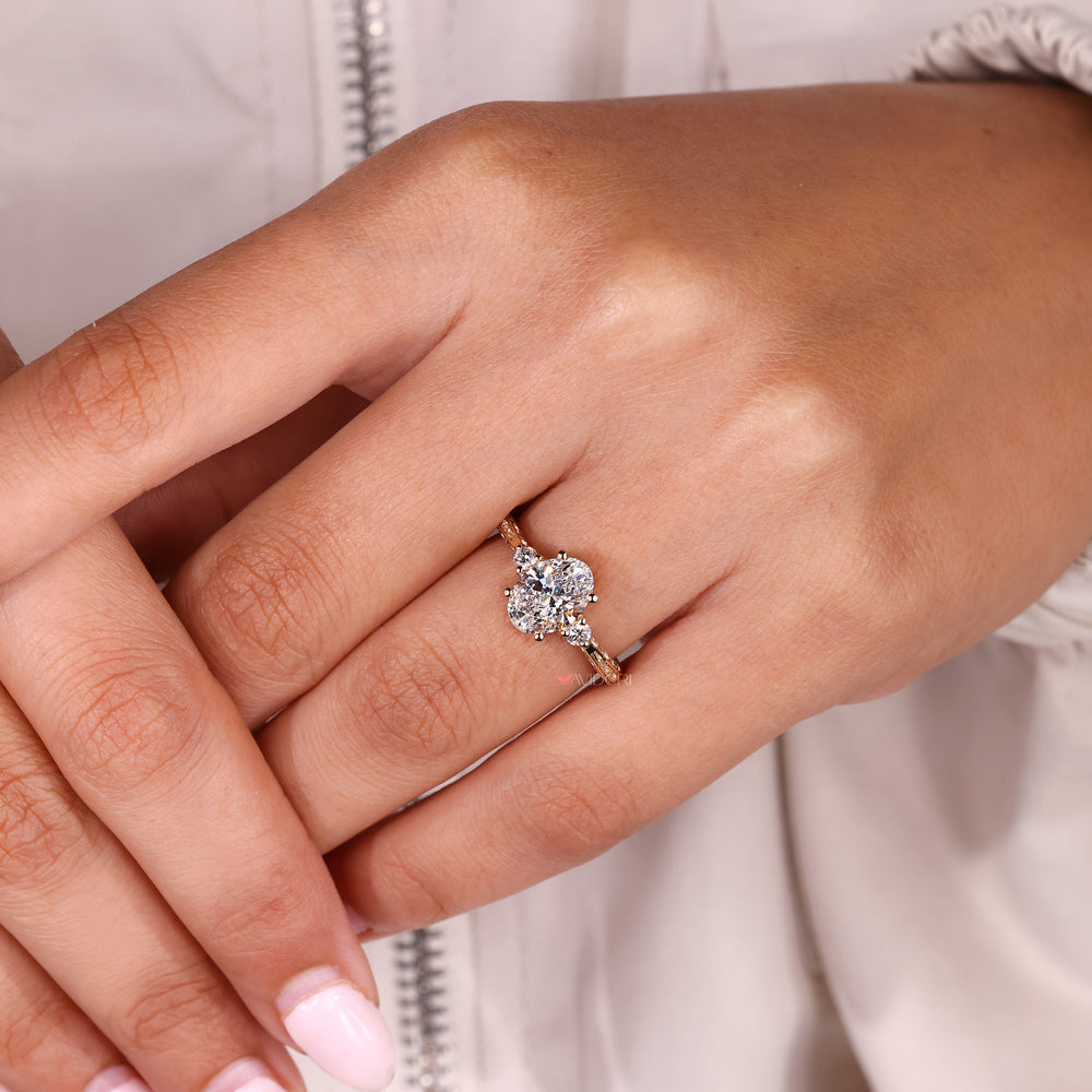 Three stone oval diamond ring with tapered shank style
