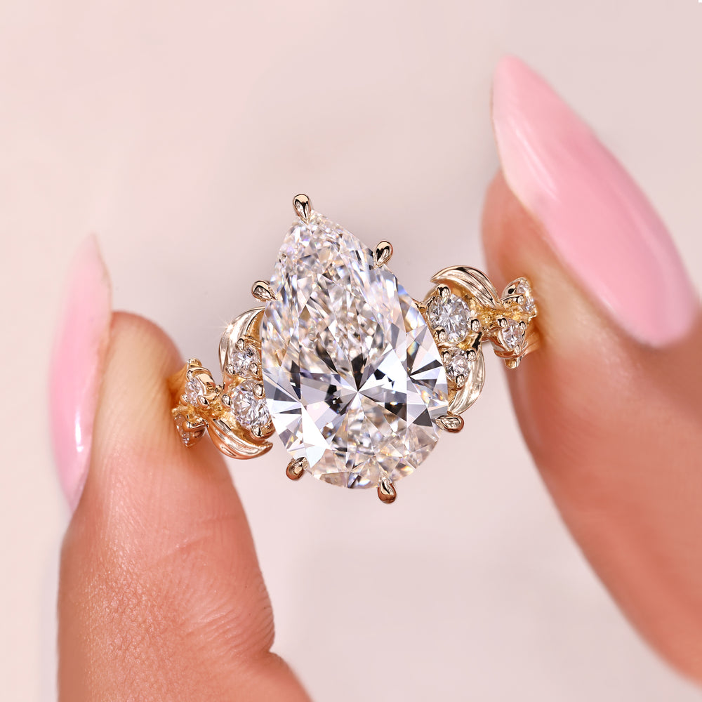 Pear cut lab grown diamond ring with secure six claw prongs.
