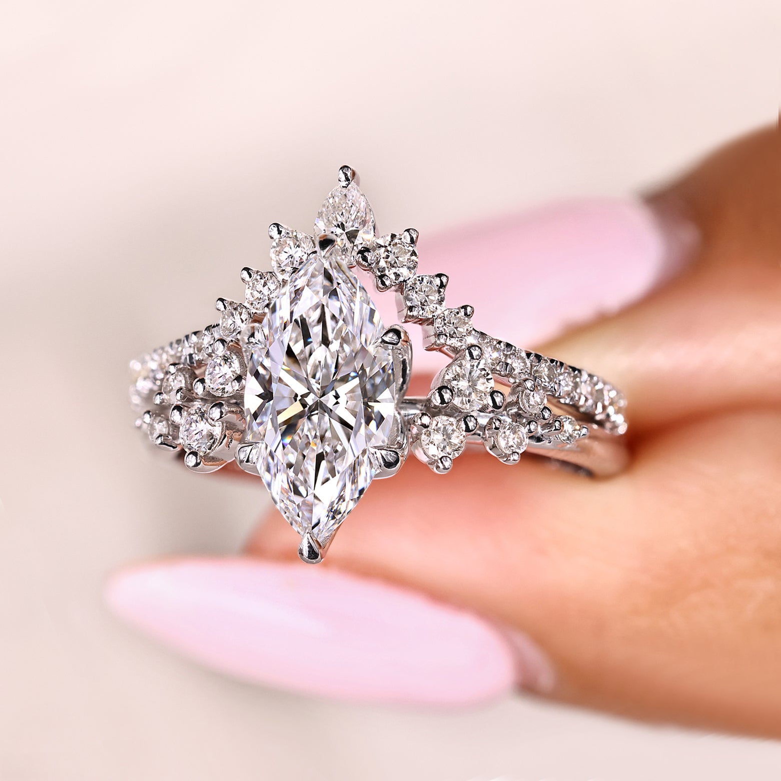 Marquise diamond ring with pear and round side stones
