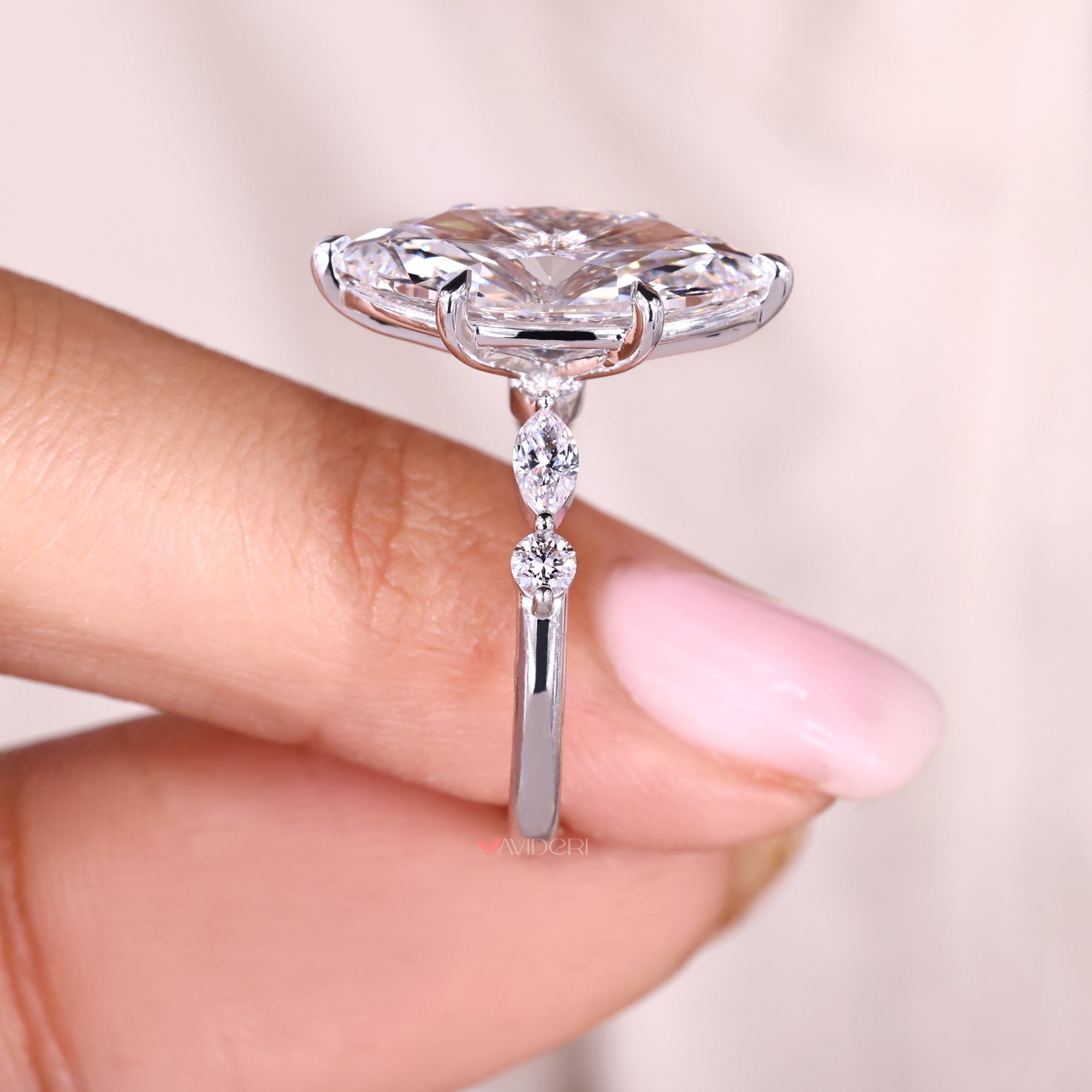 Marquise ring with side stones in shared prong setting.