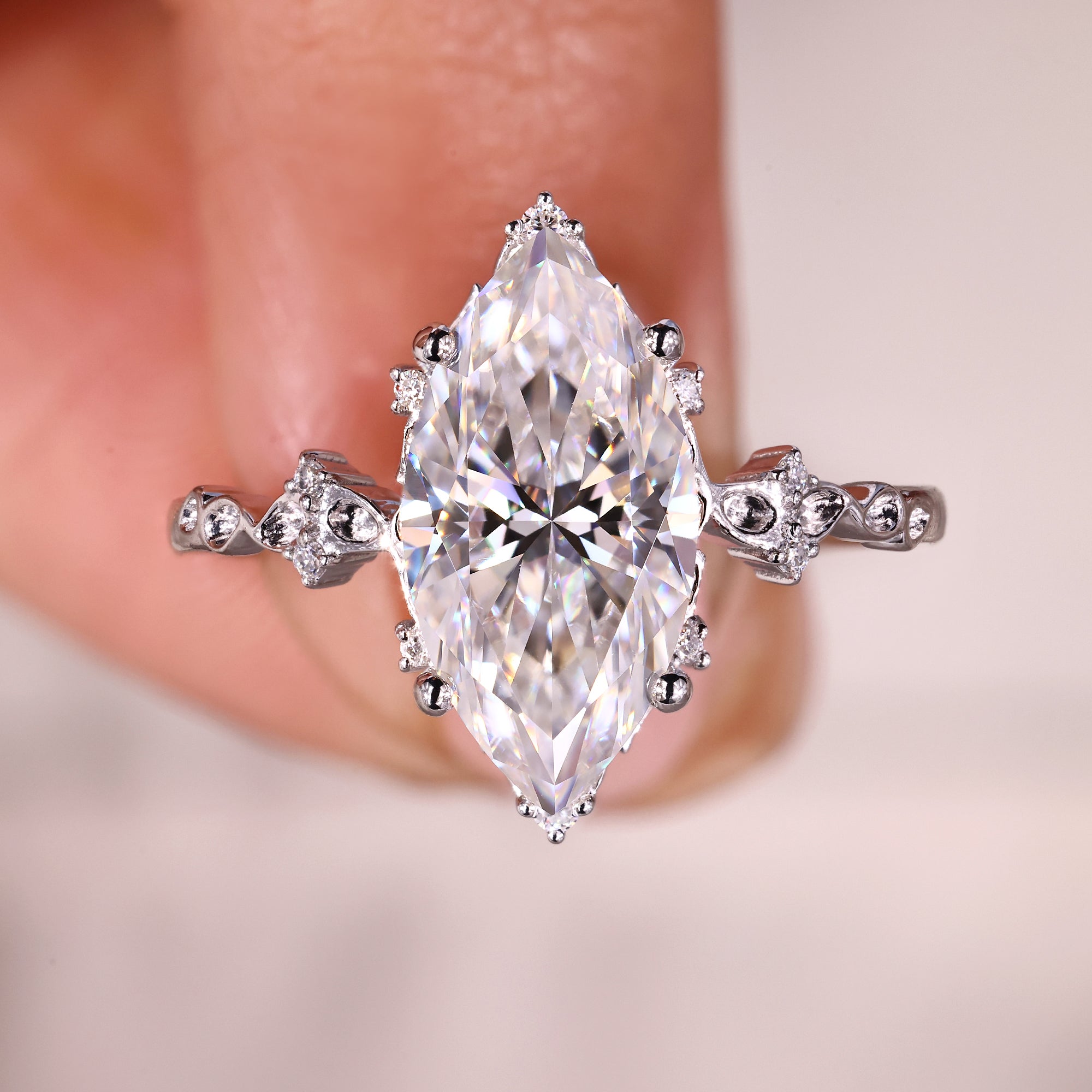 Vintage engagement ring with marquise cut moissanite and round accents.