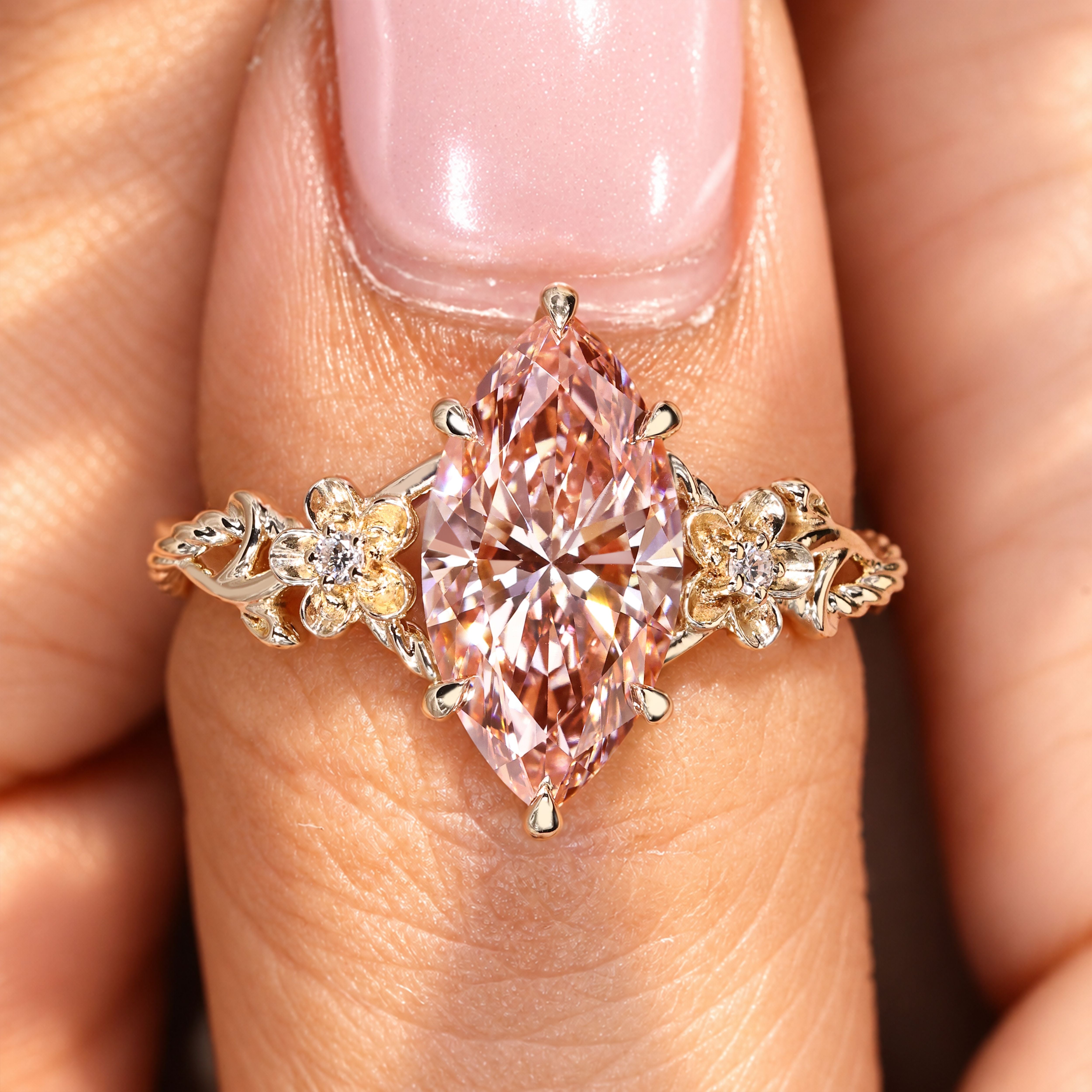 Vintage pink diamond ring with round side stones.
