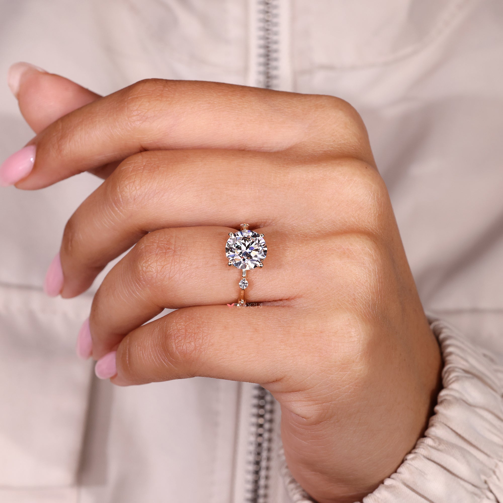 Handmade round cut diamond ring with side stones.
