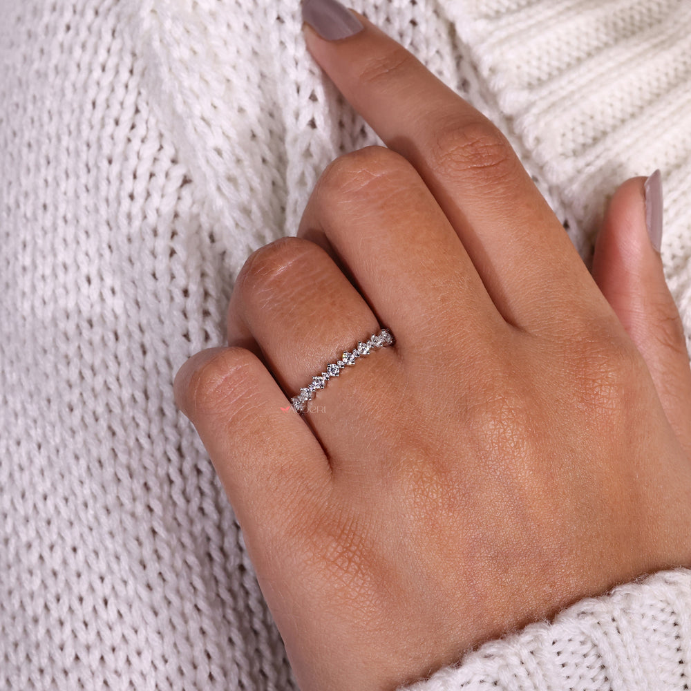 Secure prong setting holding diamonds in a beautifully crafted wedding band.
