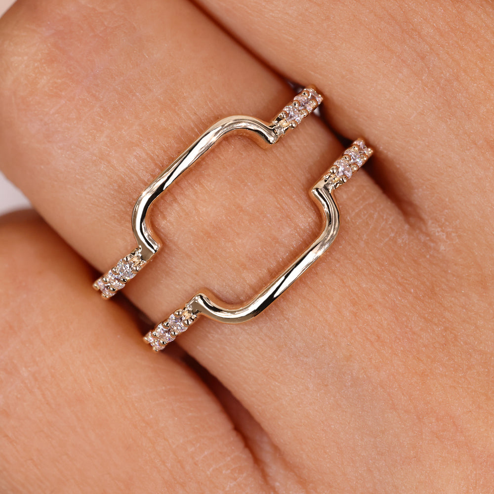 Round moissanite wrap guard wedding band in yellow gold.