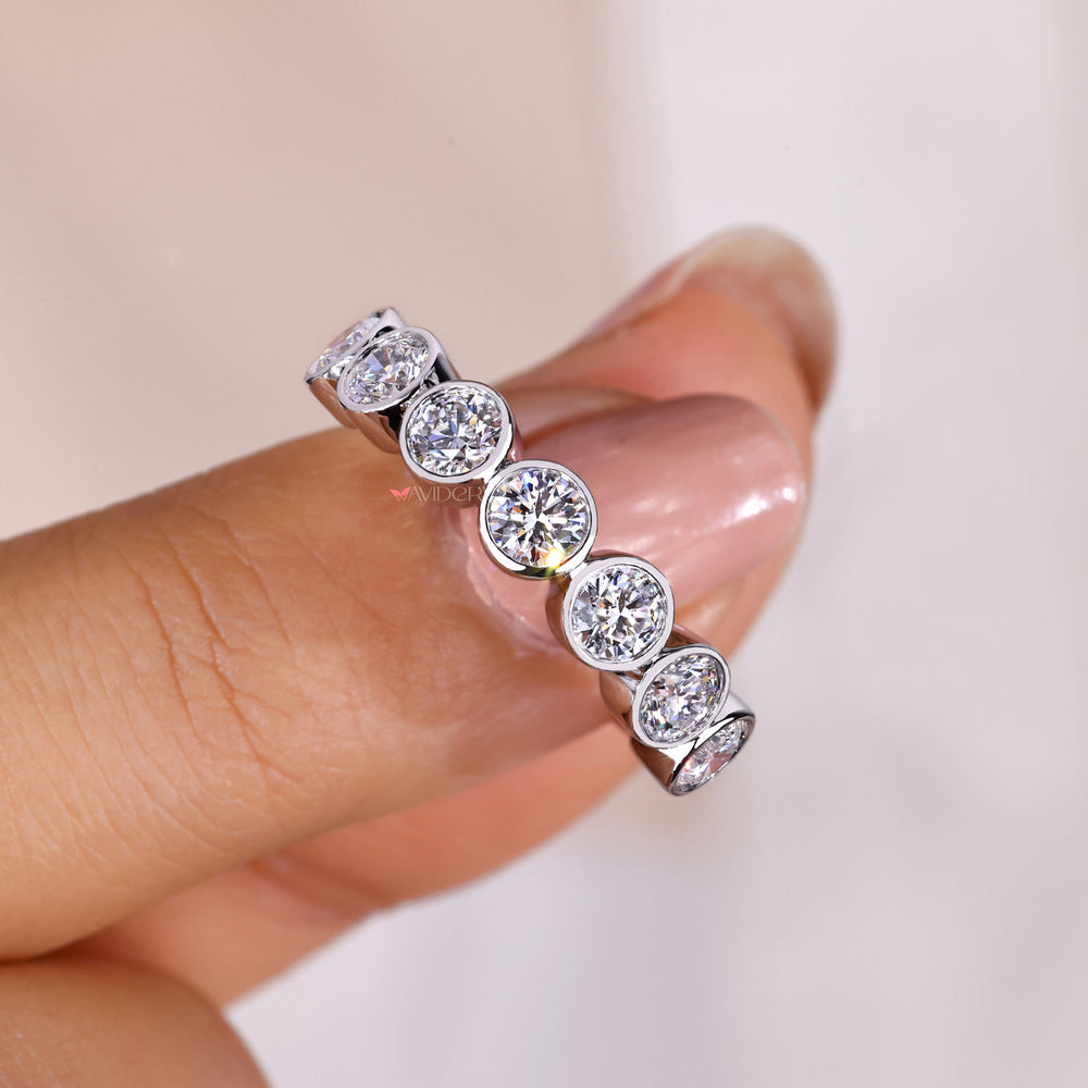 Handmade band with bezel set round cut diamonds.
