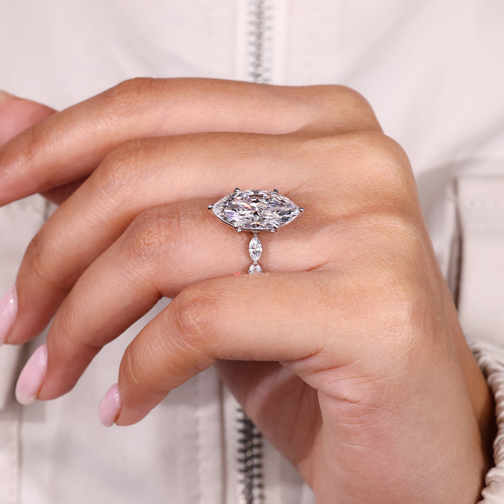 Custom diamond ring with marquise center and side stones.