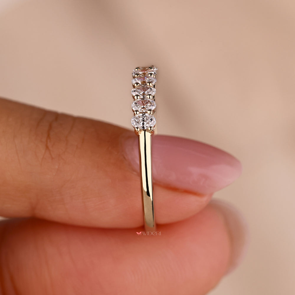 Oval half eternity band with continuous diamonds.
