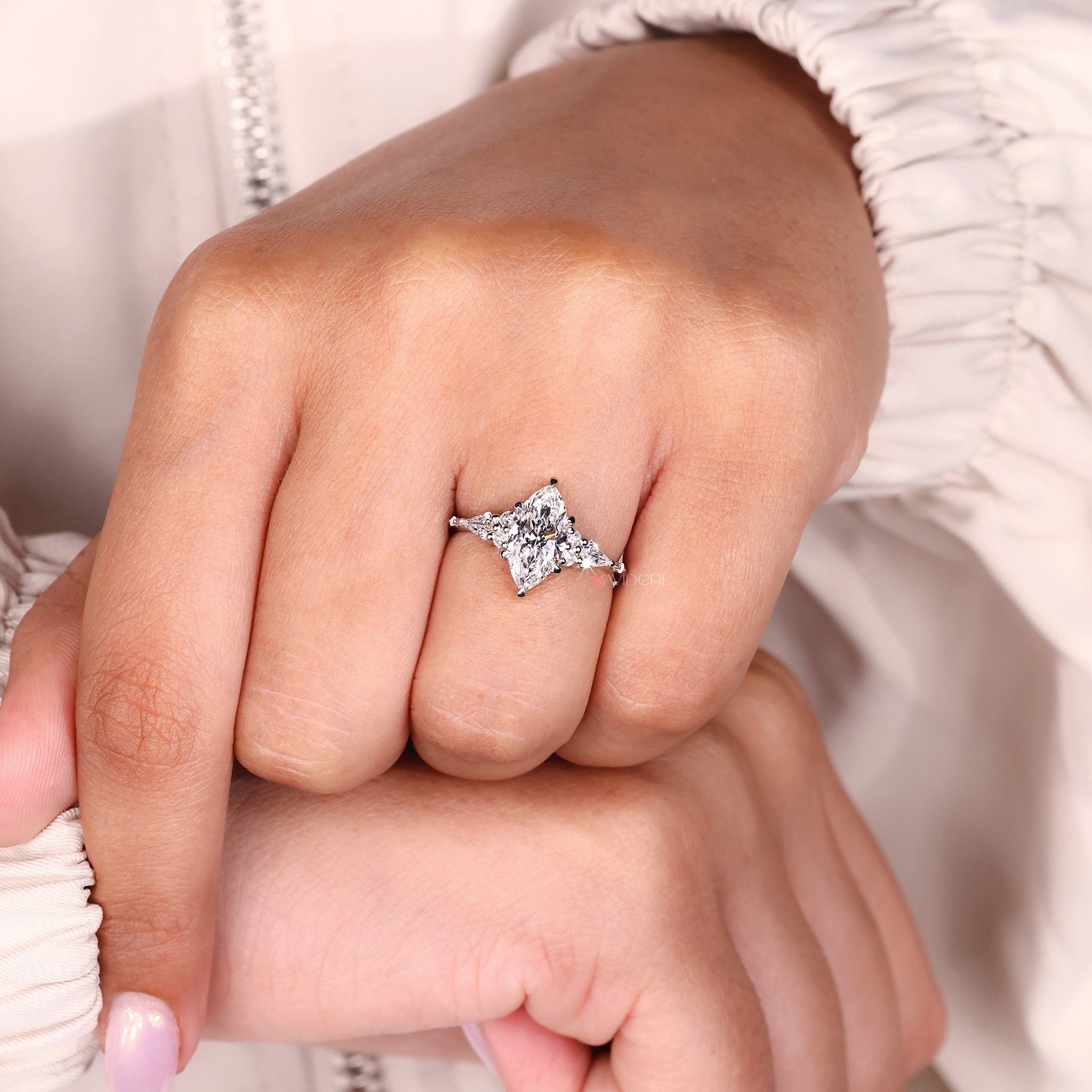 Six claw prong setting secures center stone with strength and style.

